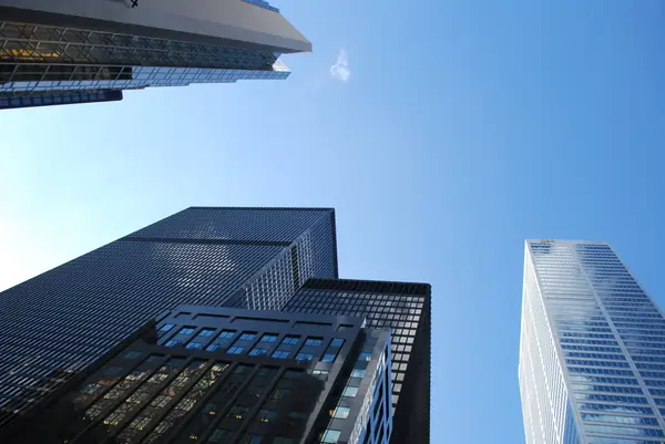 blue sky with skyscrapers surrounding