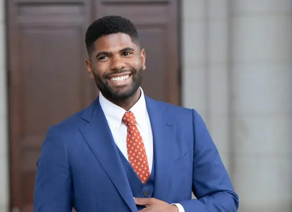 man in blue suit smiling