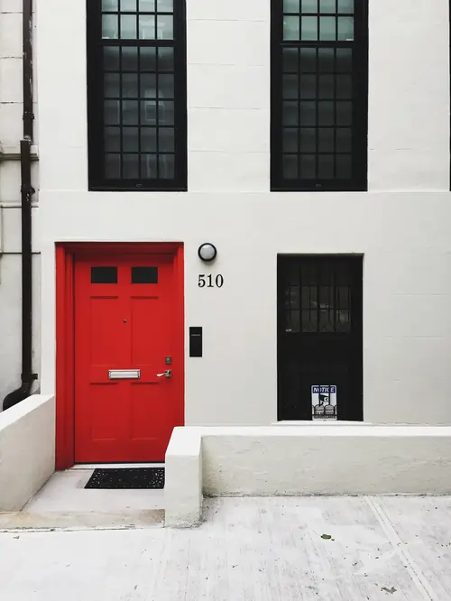 jmc red door on white building
