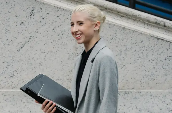 woman in grey suit smiling