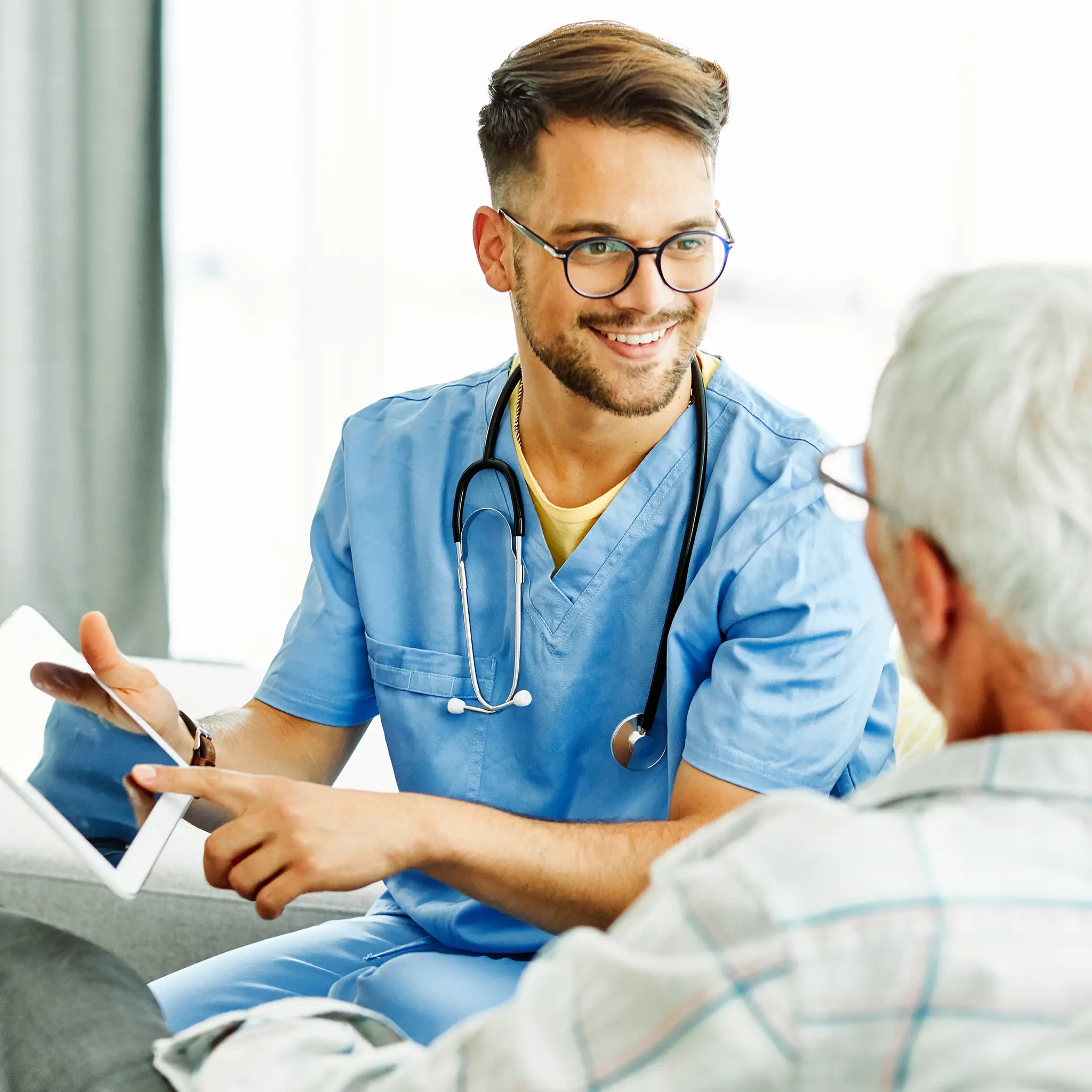 male-doctor-engaging-with-elderly-patient