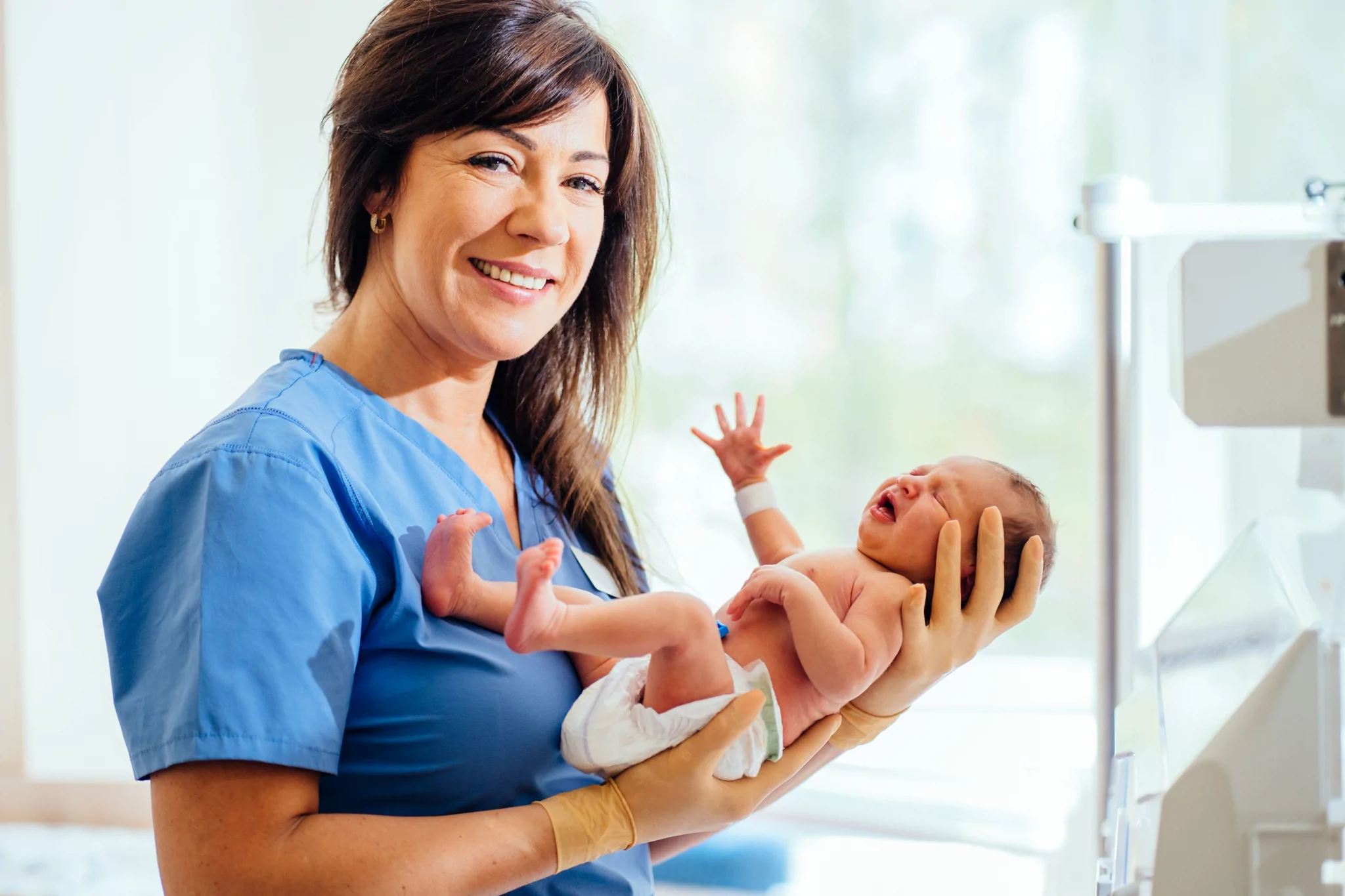 midwife-holding-a-newborn-baby