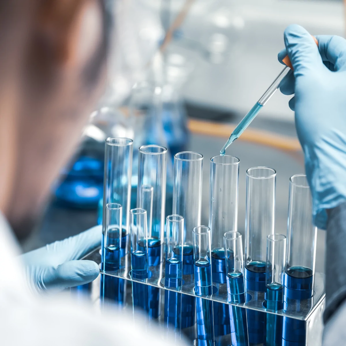 a close up of a scientist using test tubes