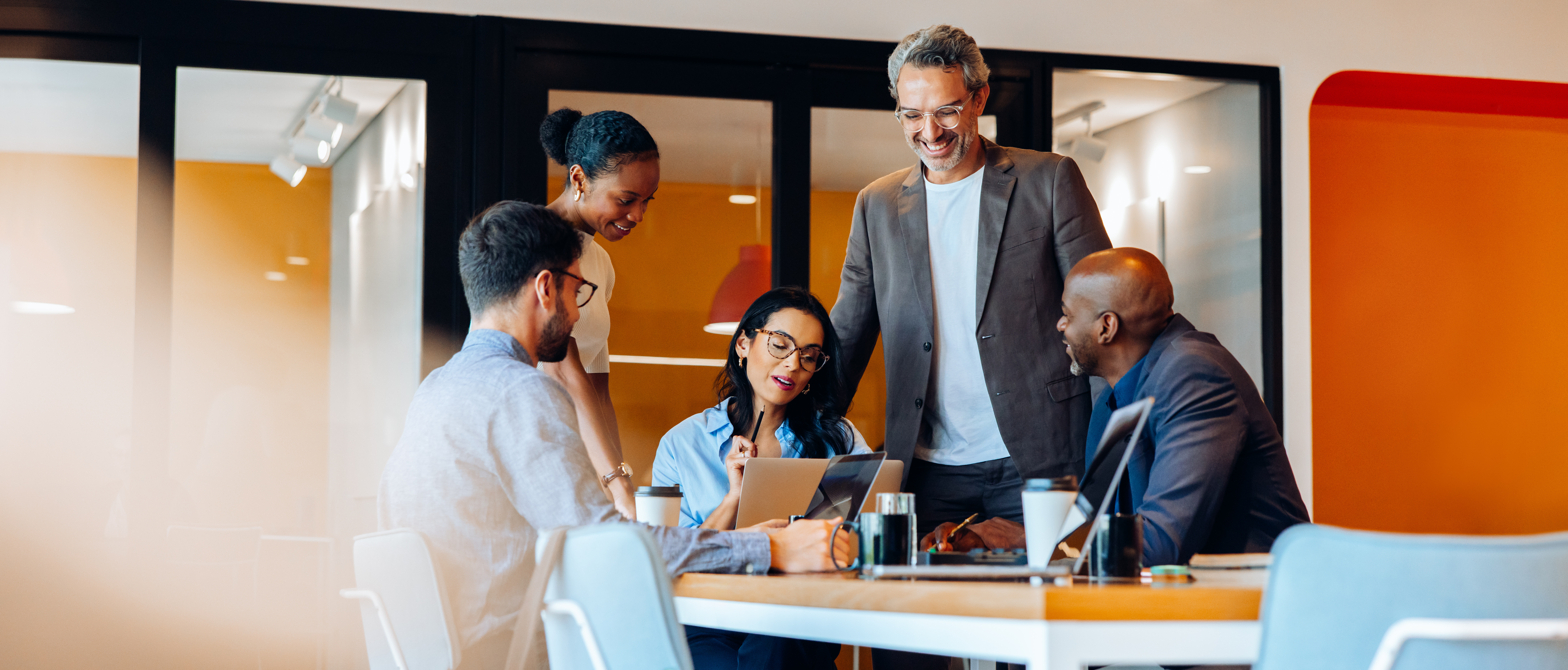  group of professionals discussing ideas around a table
