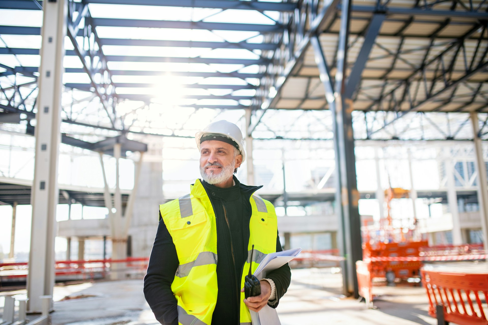 front-view-of-man-engineer-with-walkie-talkie-standing-on-construction-site