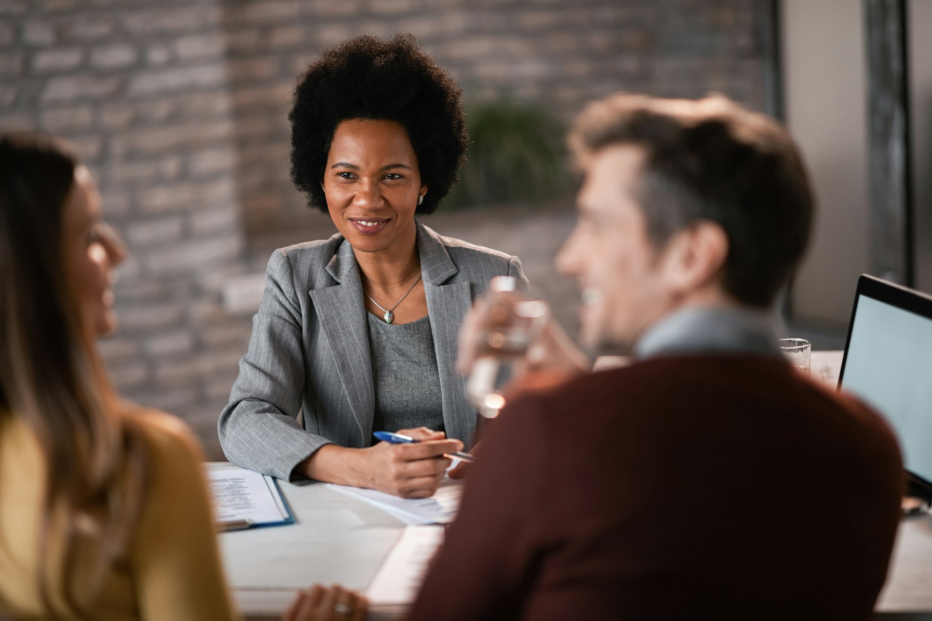 happy-african-american-financial-advisor-having-a-meeting-with-a-couple-and-talking-with-them-about-their-investment-possibilities-