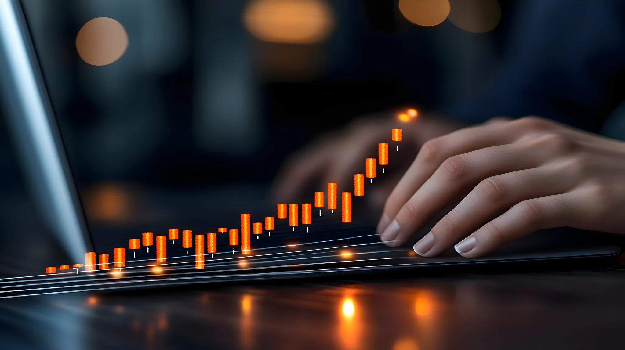 Female hands typing on laptop while sitting at office desk indoors.