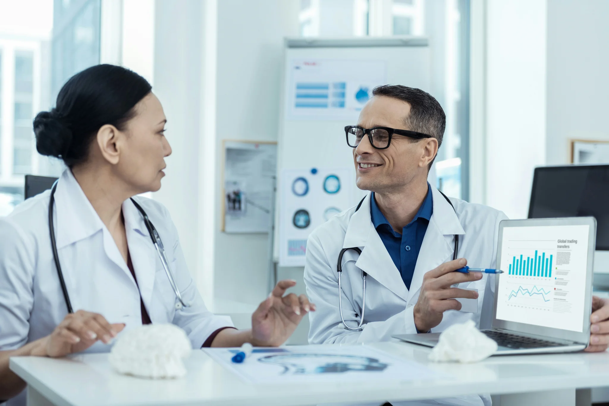 healthcare consultant pointing at graph