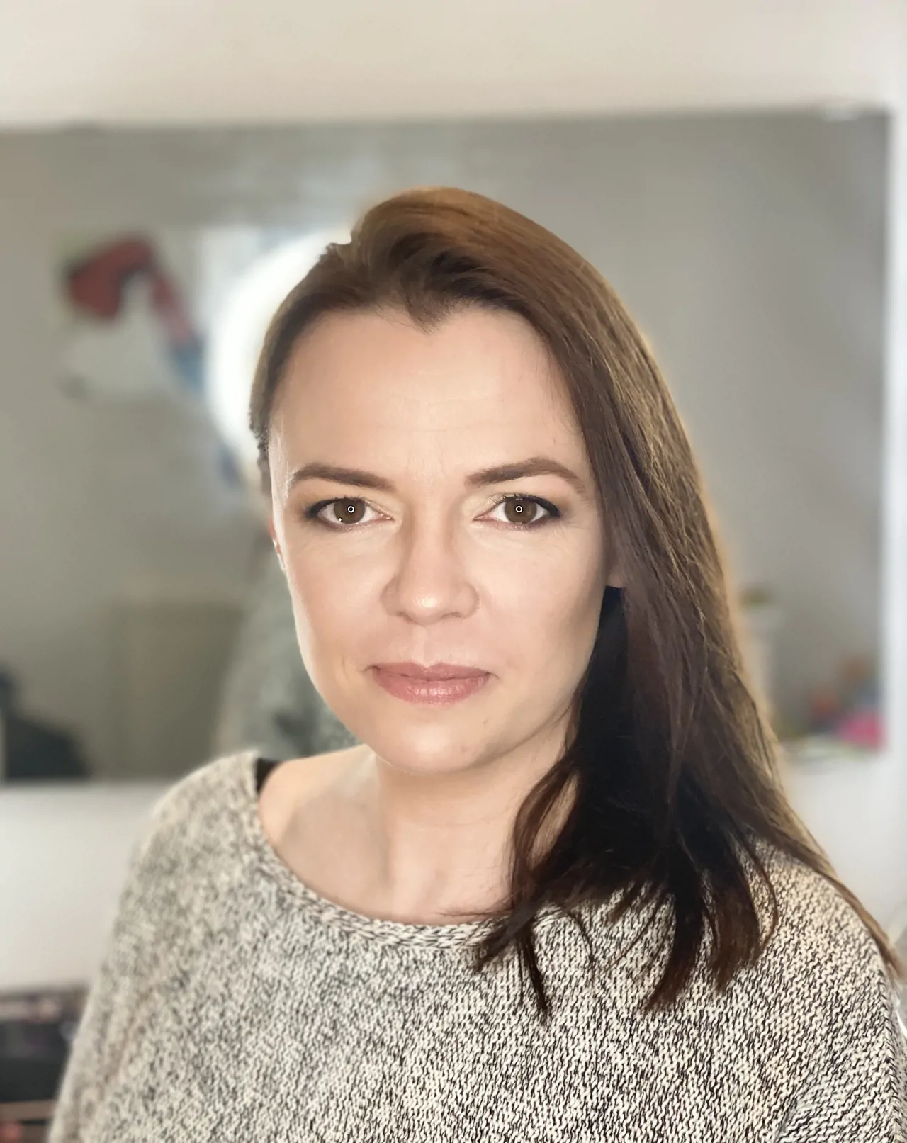 Woman with dark hair wearing gey jumper photo