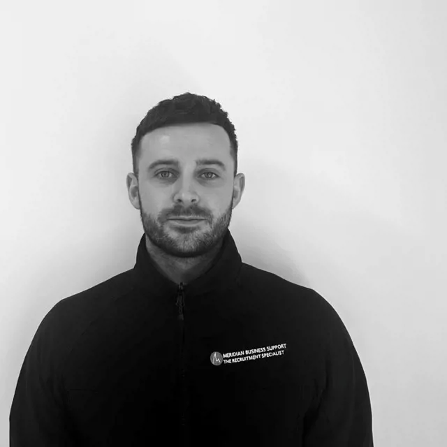 Headshot photo of man in Meridian branded black jacket