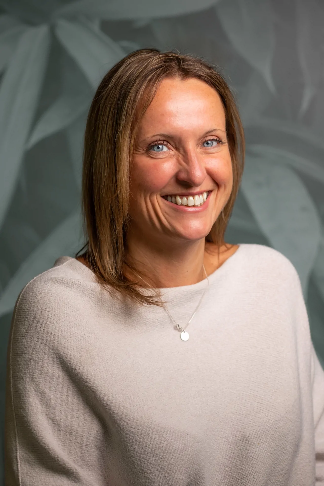 Senior HR Leader wearing jumper and smiling for headshot photo