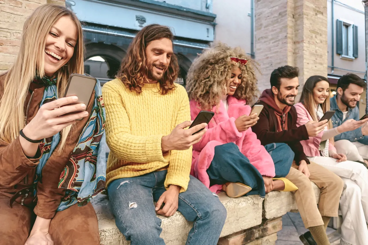 Six people laughing at their phones