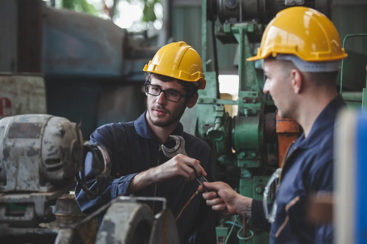 Two mechanics working on equipment 