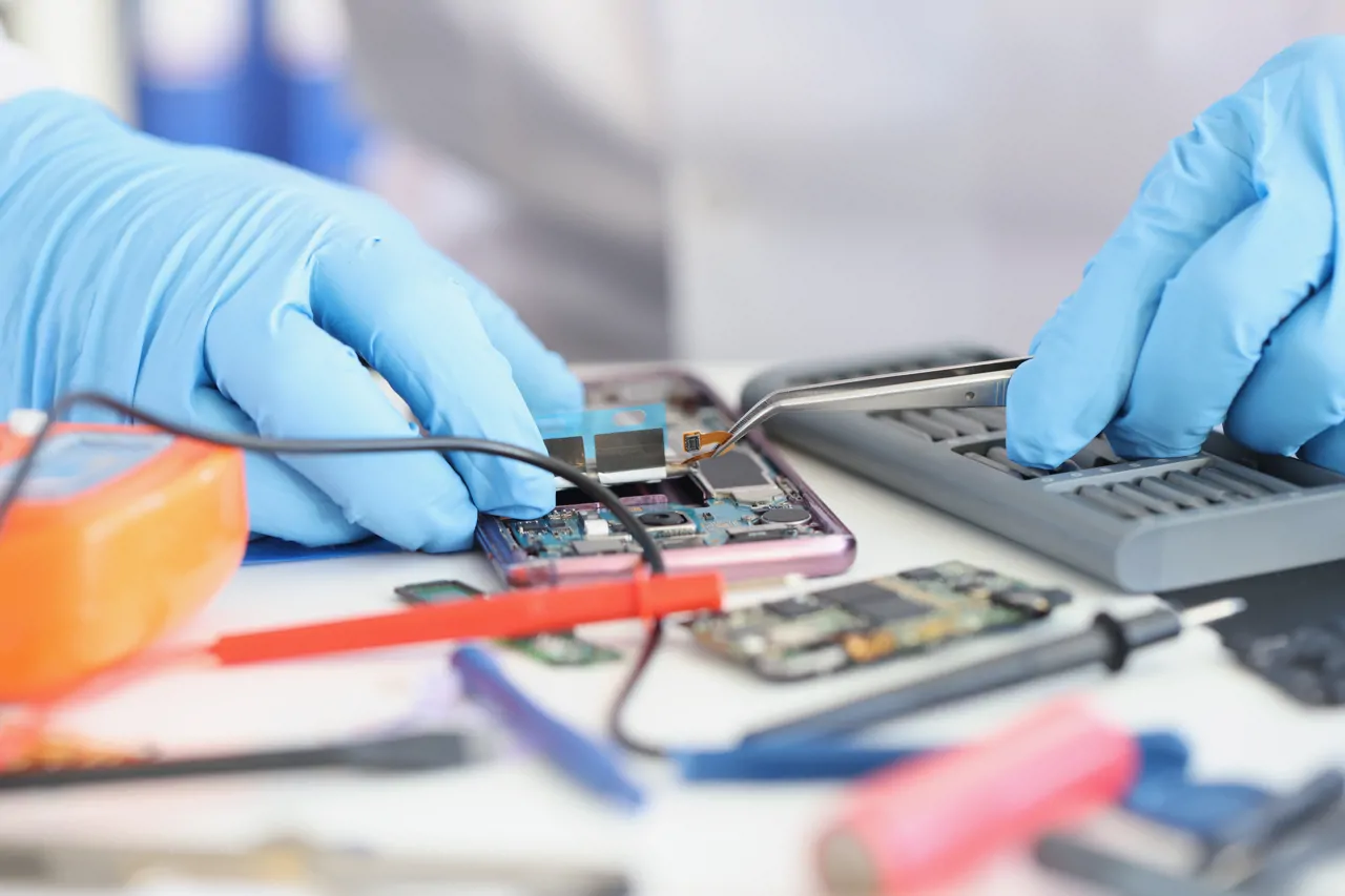 A technician fixing the inside of a smartphone