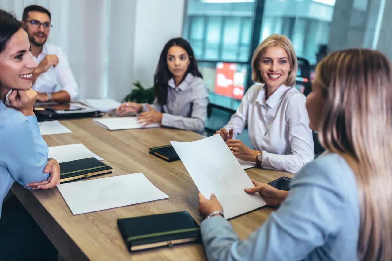 A team of people working in an office smiling