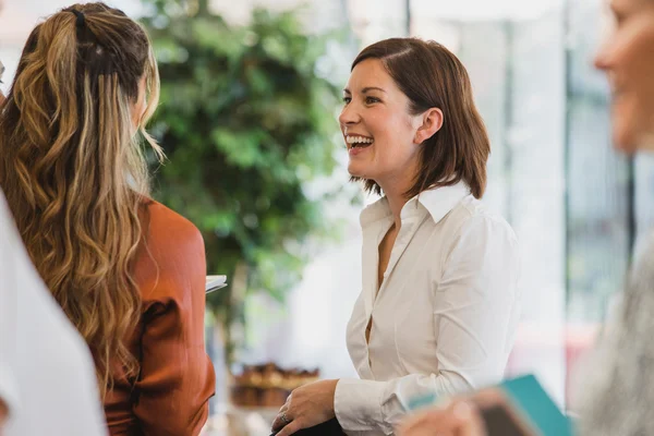 Cheerful colleagues laughing during corporate meeting