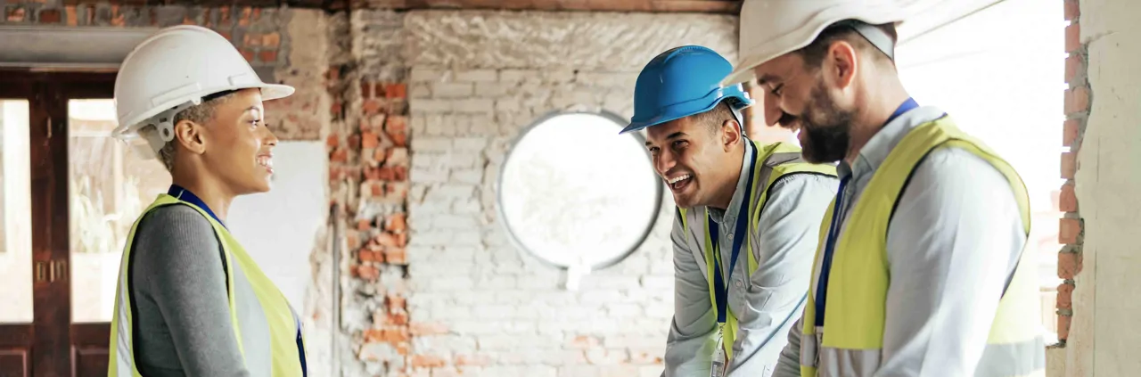 Construction workers wearing hard hats on building site