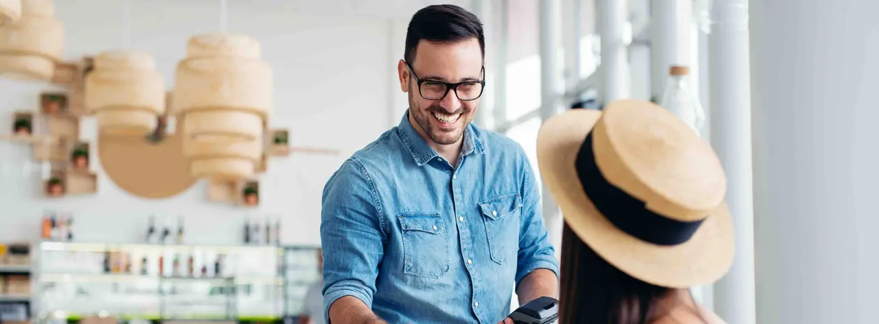 Barista smiling with customer