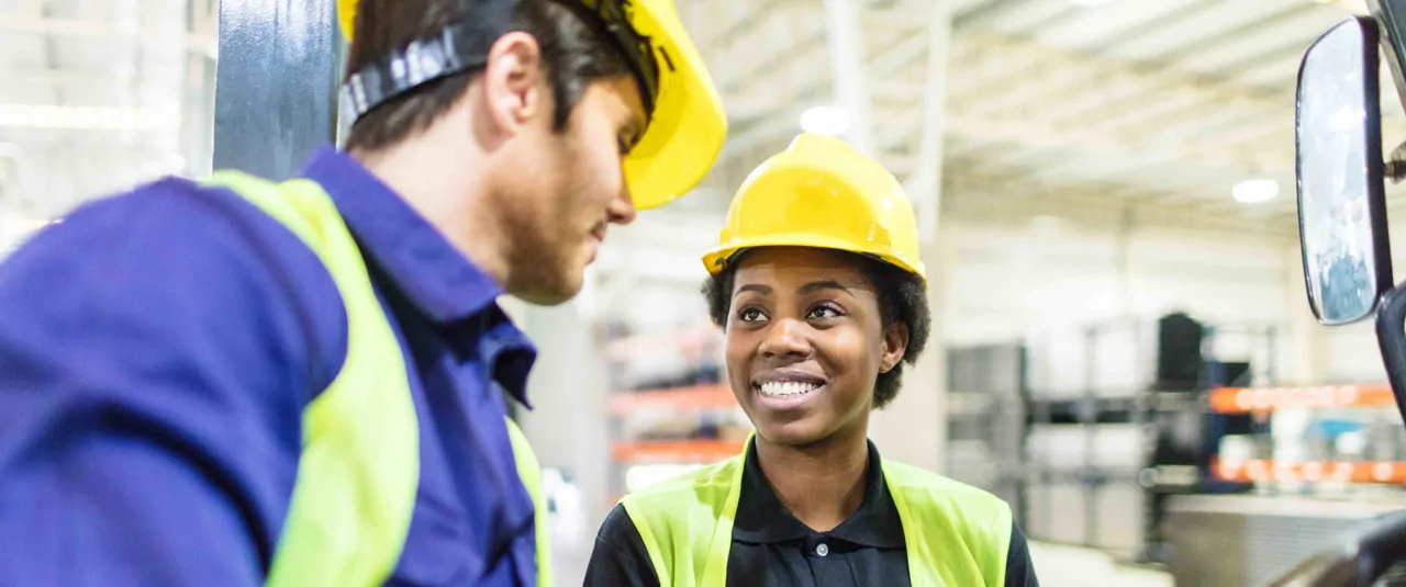 Warehouse workers wearing hard hats