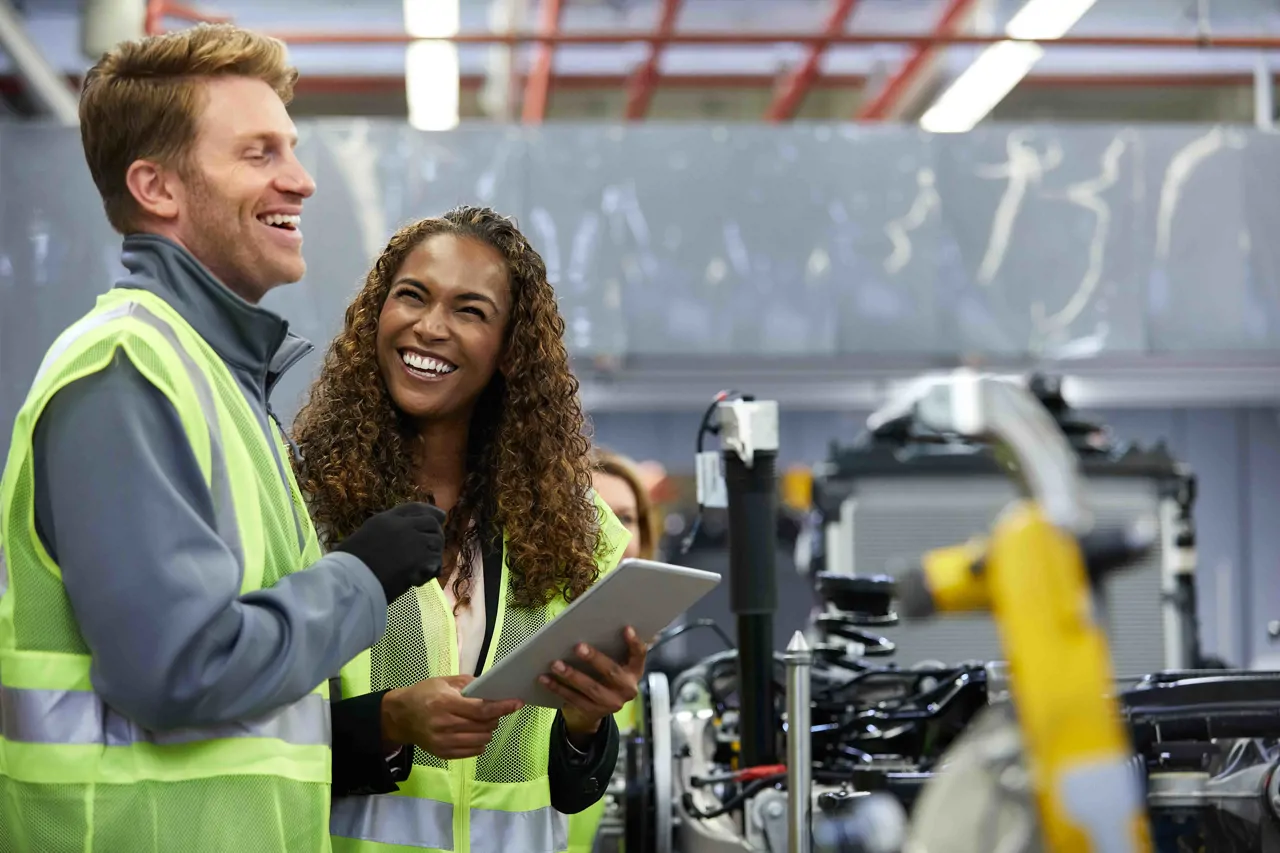 Two production operatives wearing high visibility