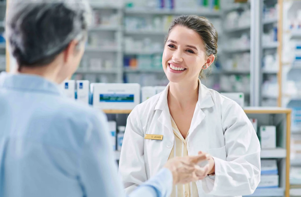 Female pharmasist supporting a customer