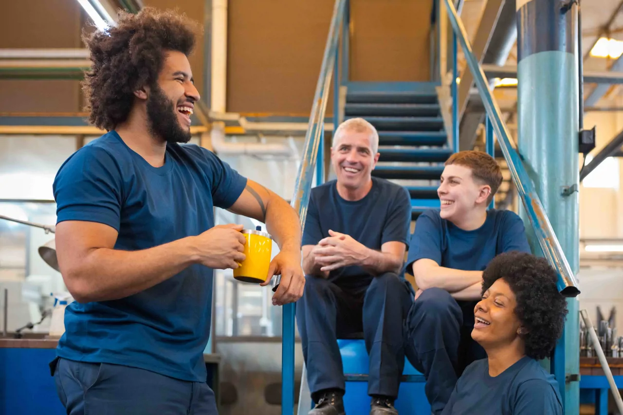 Four industrial workers sitting down having a break