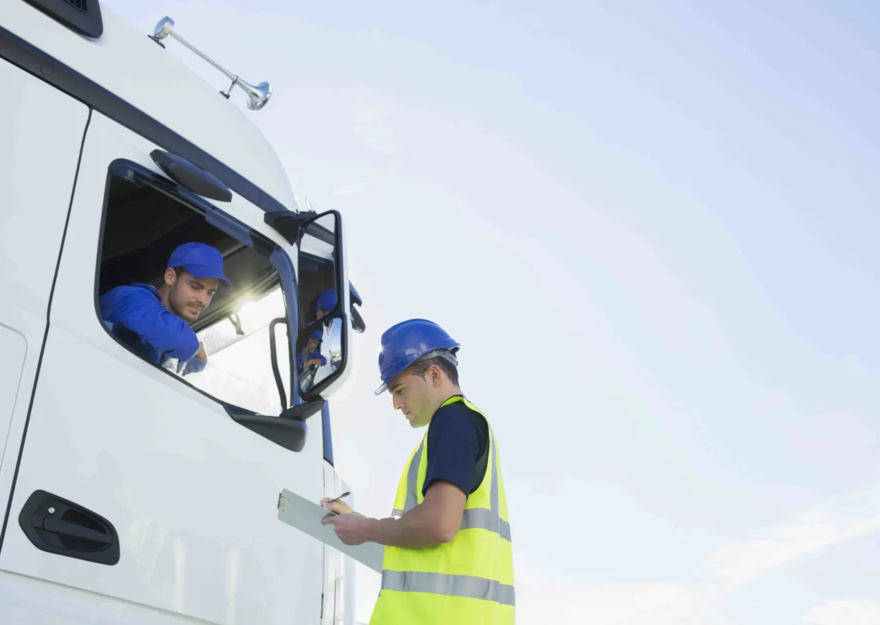 An industrial driver talking to colleague