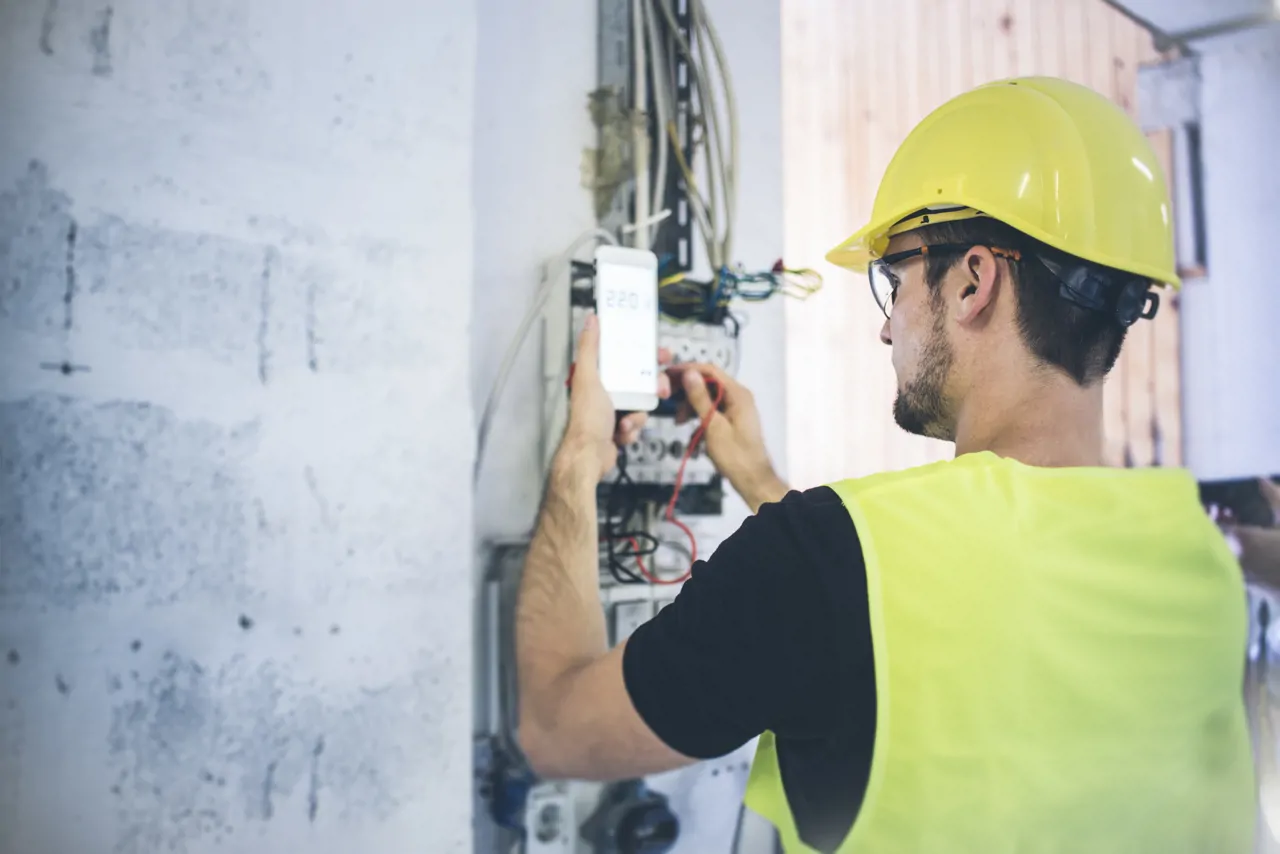 An electrician checking his work