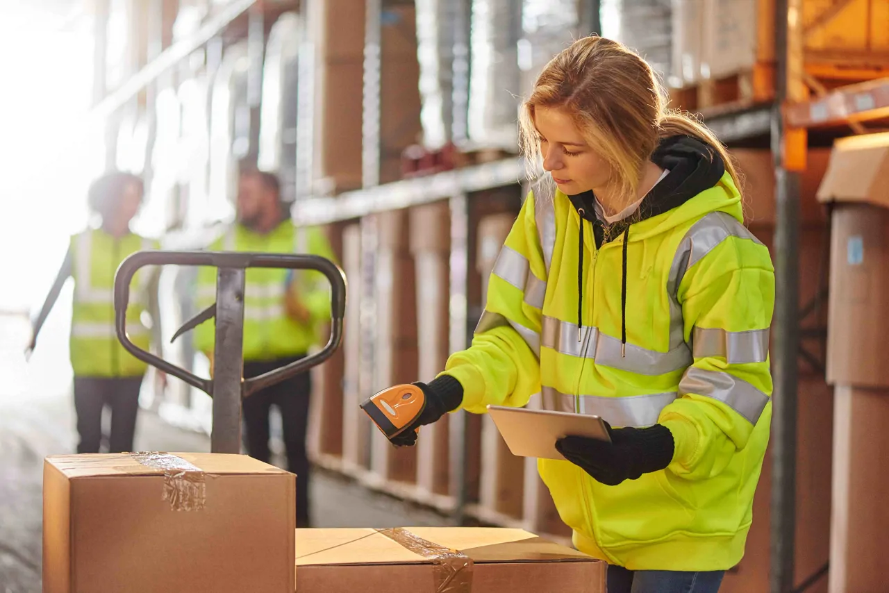 Warehouse worker scanning boxes for inventory