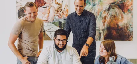 Group of four colleagues working together on a project