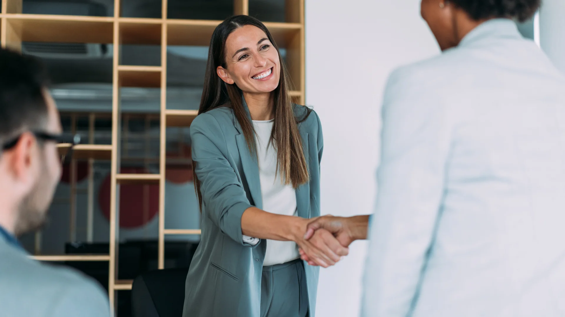 Business leaders handshaking during a meeting in a modern office to signify successful partnership