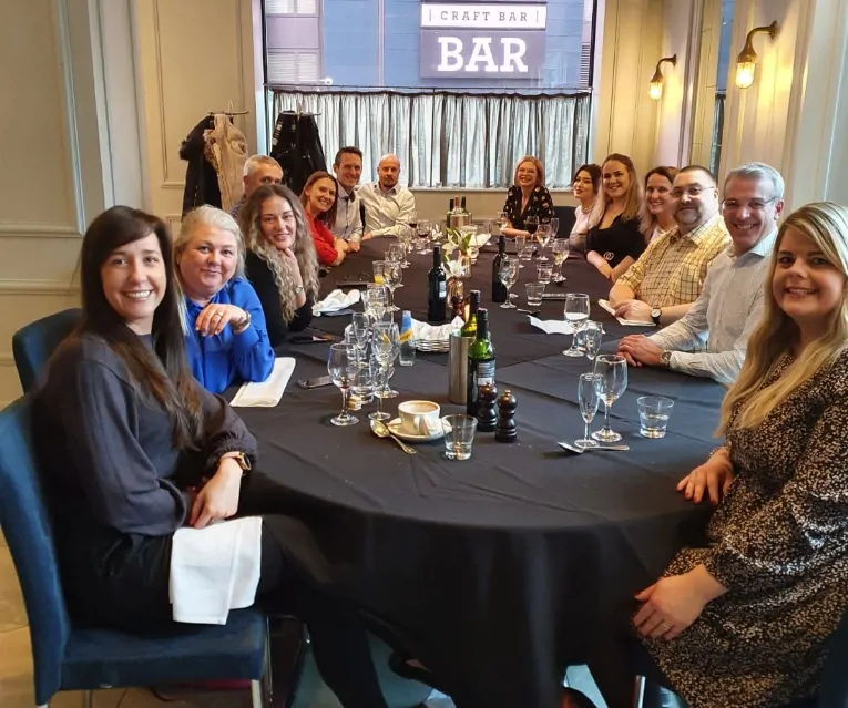 Colleagues sat together at a table in a restaurant