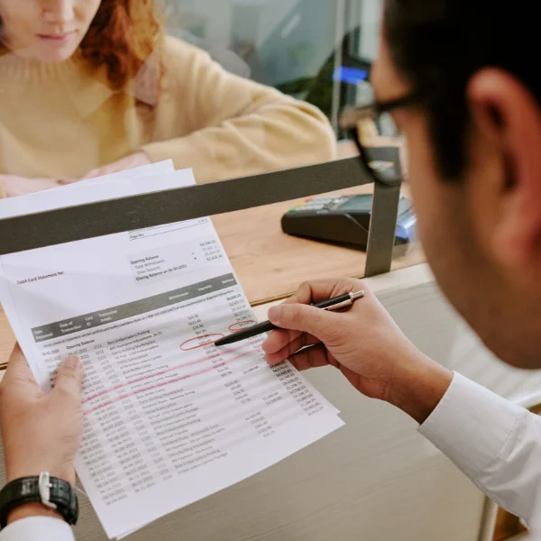 Retail banker highlighting essential details on bank statement