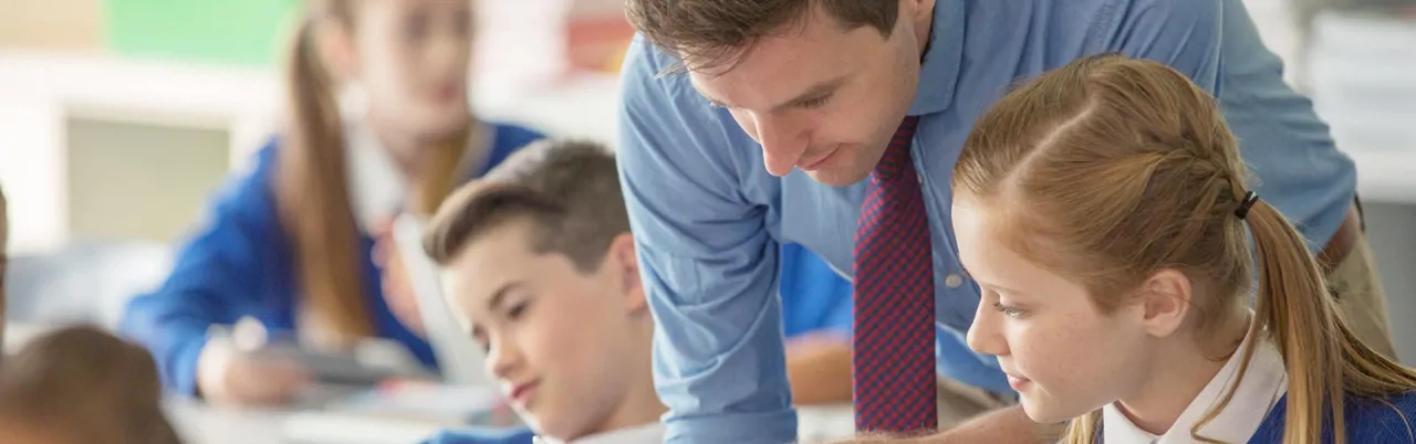 A male secondary school teacher with students