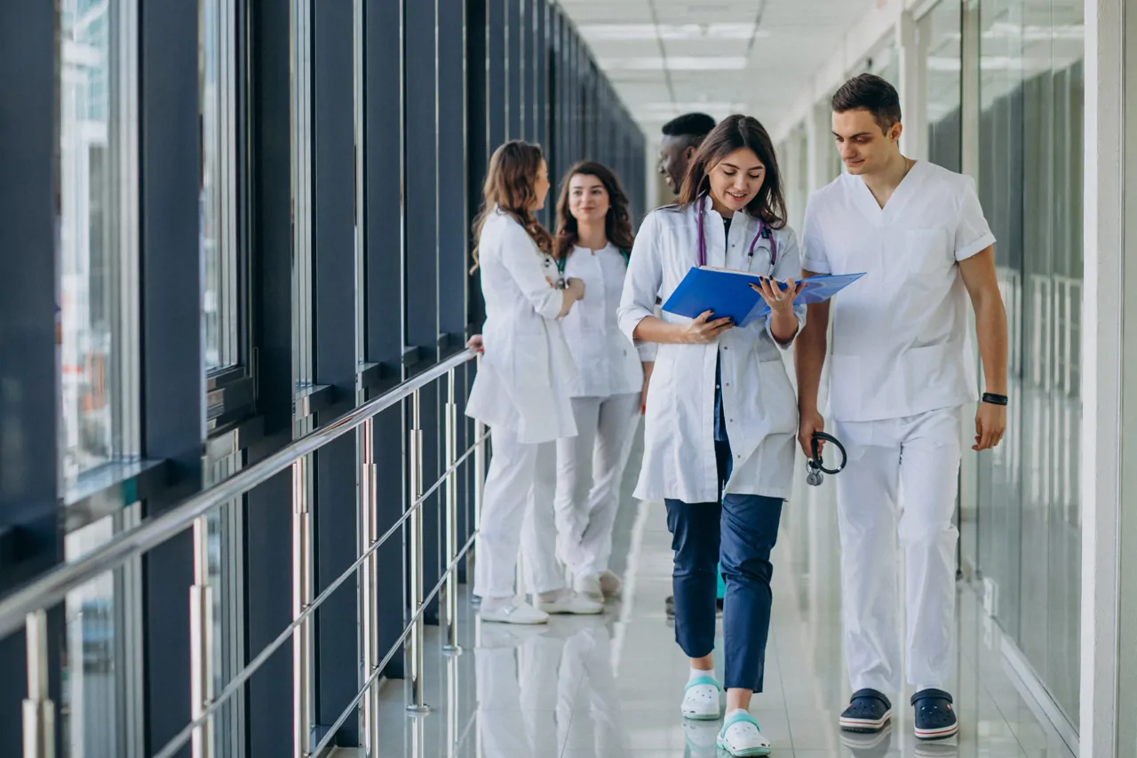 Healthcare staff looking at notes while walking through clinic