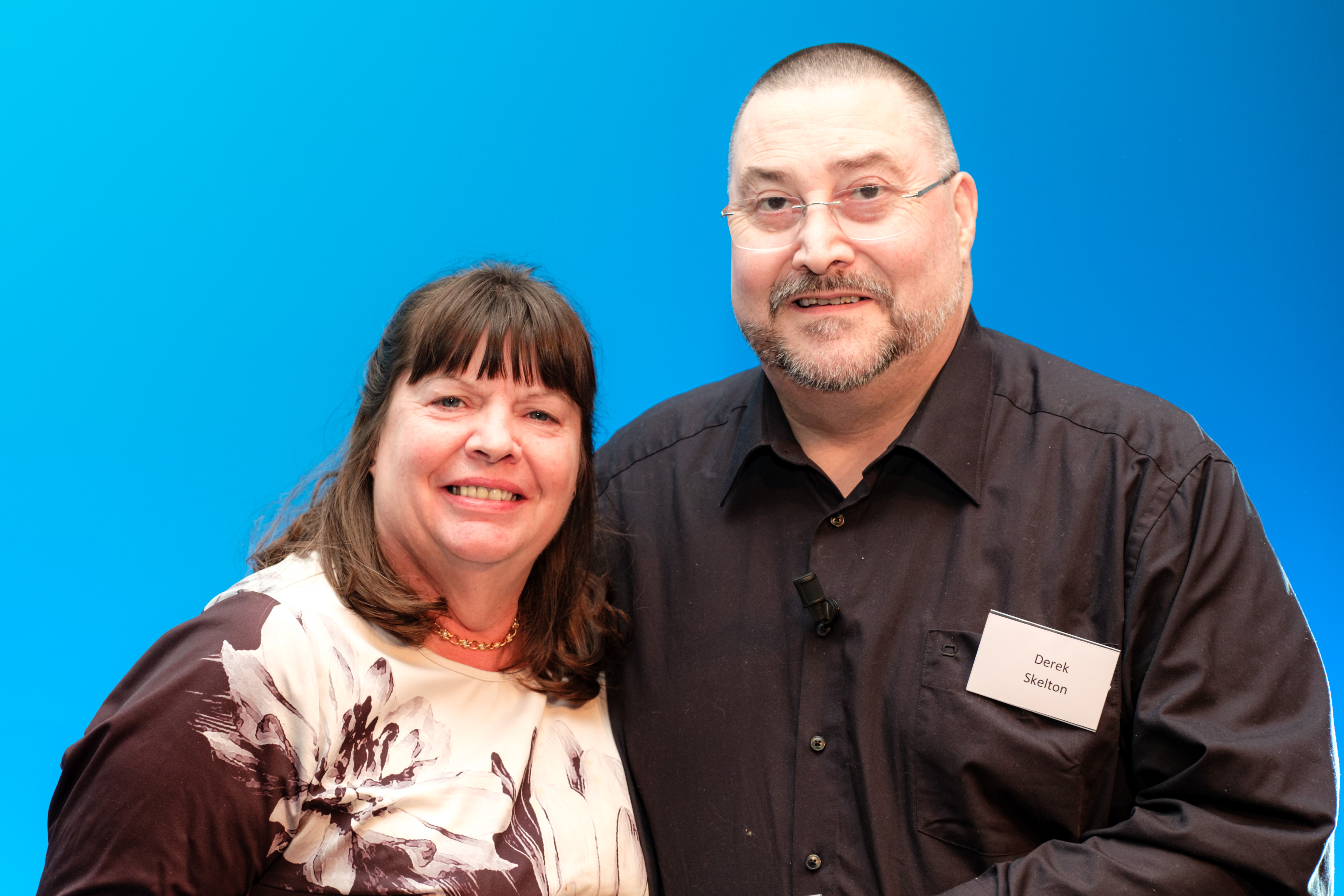 Meridian Annual Conference & Awards: Winner photo on stage of Community Champion next to Meridian's CEO