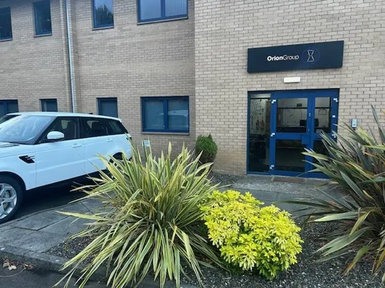 A car parked in front of a buildingAI-generated content may be incorrect.
