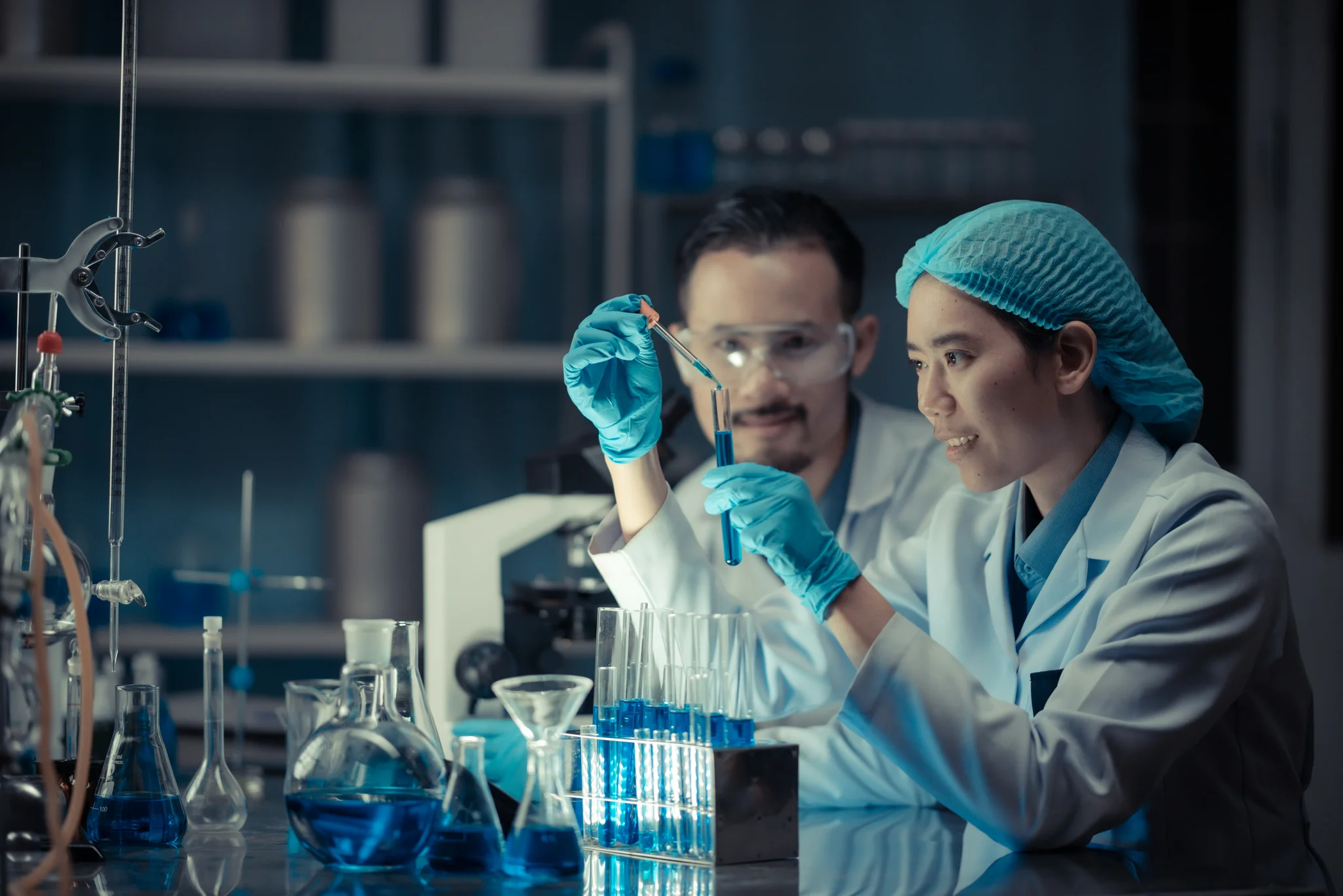 man and woman working together in a lab 