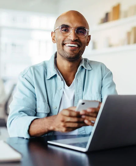 man smiling at desk