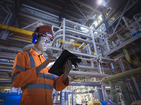 man on device in a oil and gas facility