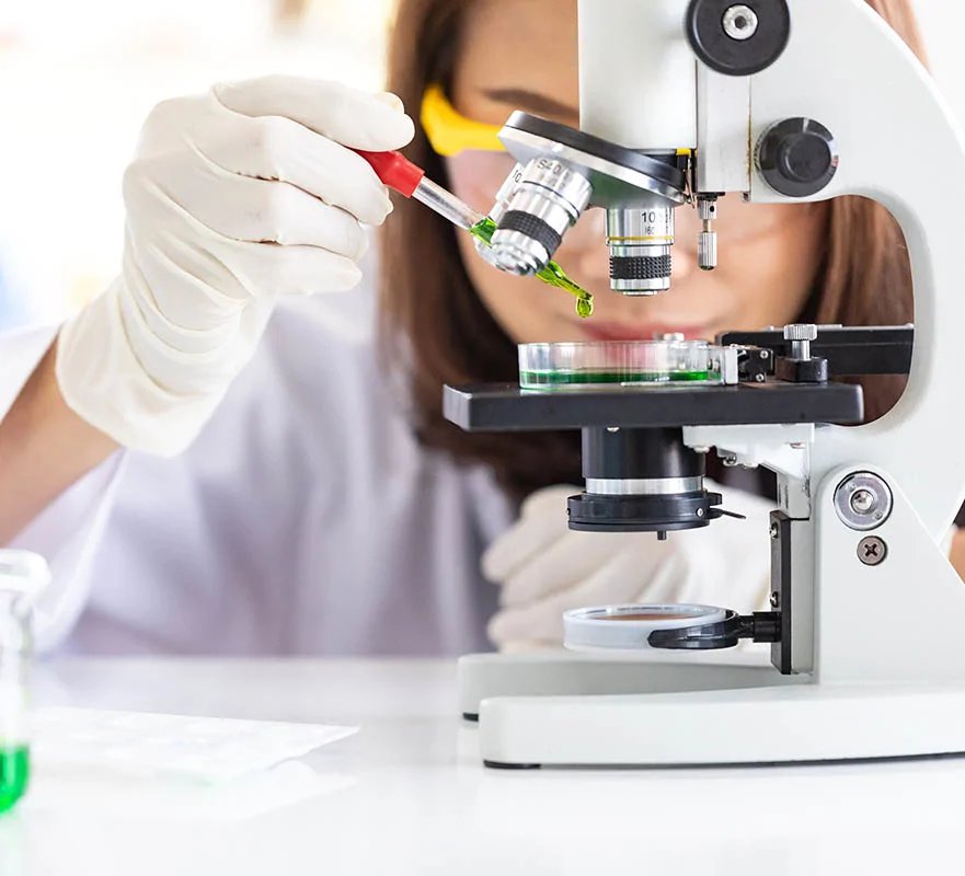 woman looking at microscope