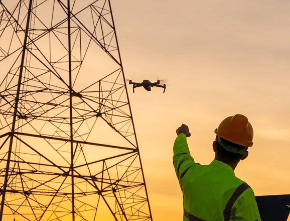 man with drone at pylon