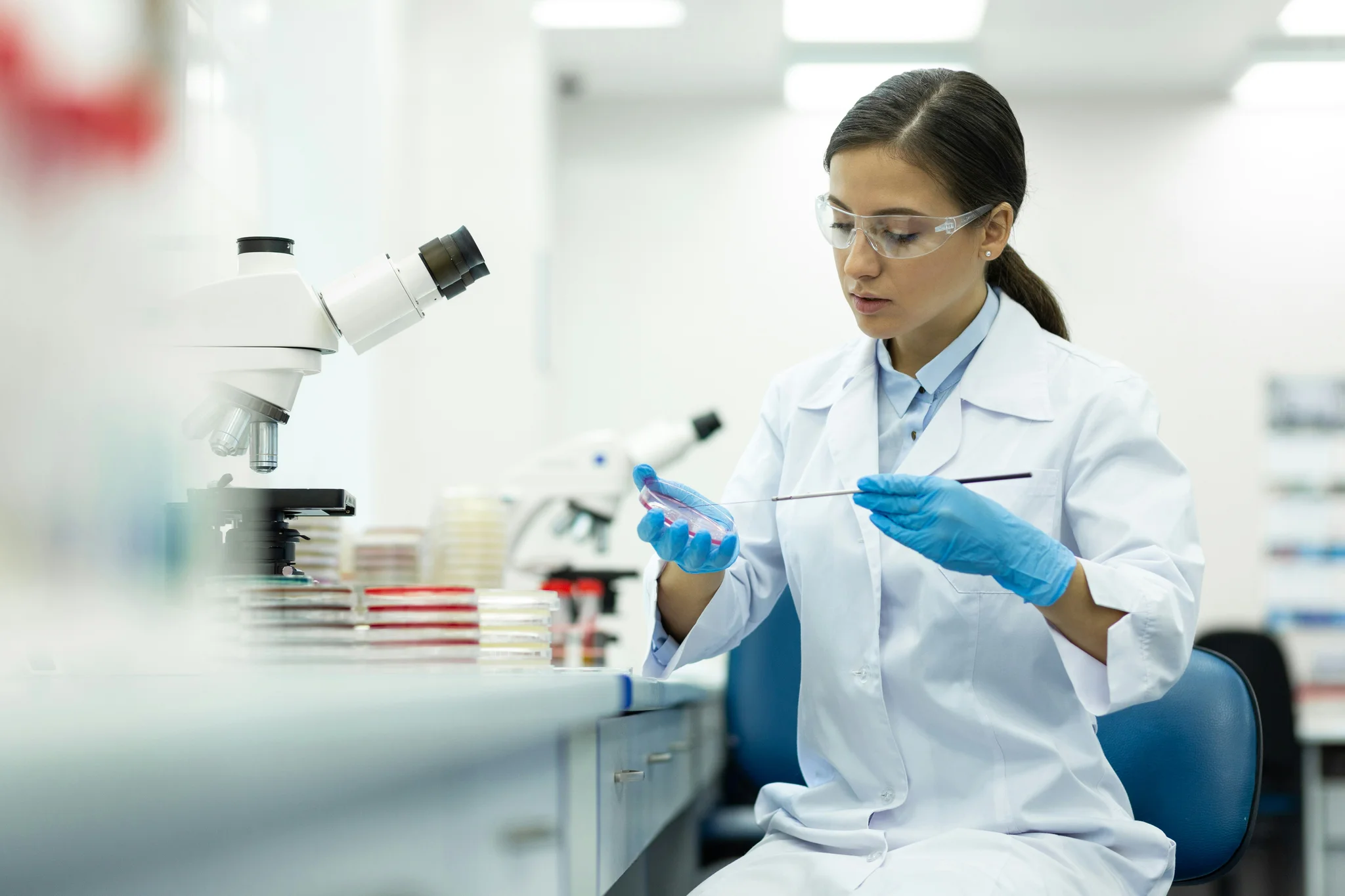 Woman in lab with a petri dish