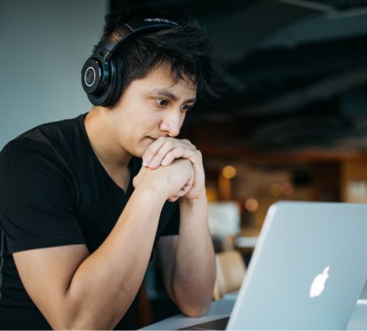 Male looks at Mac screen