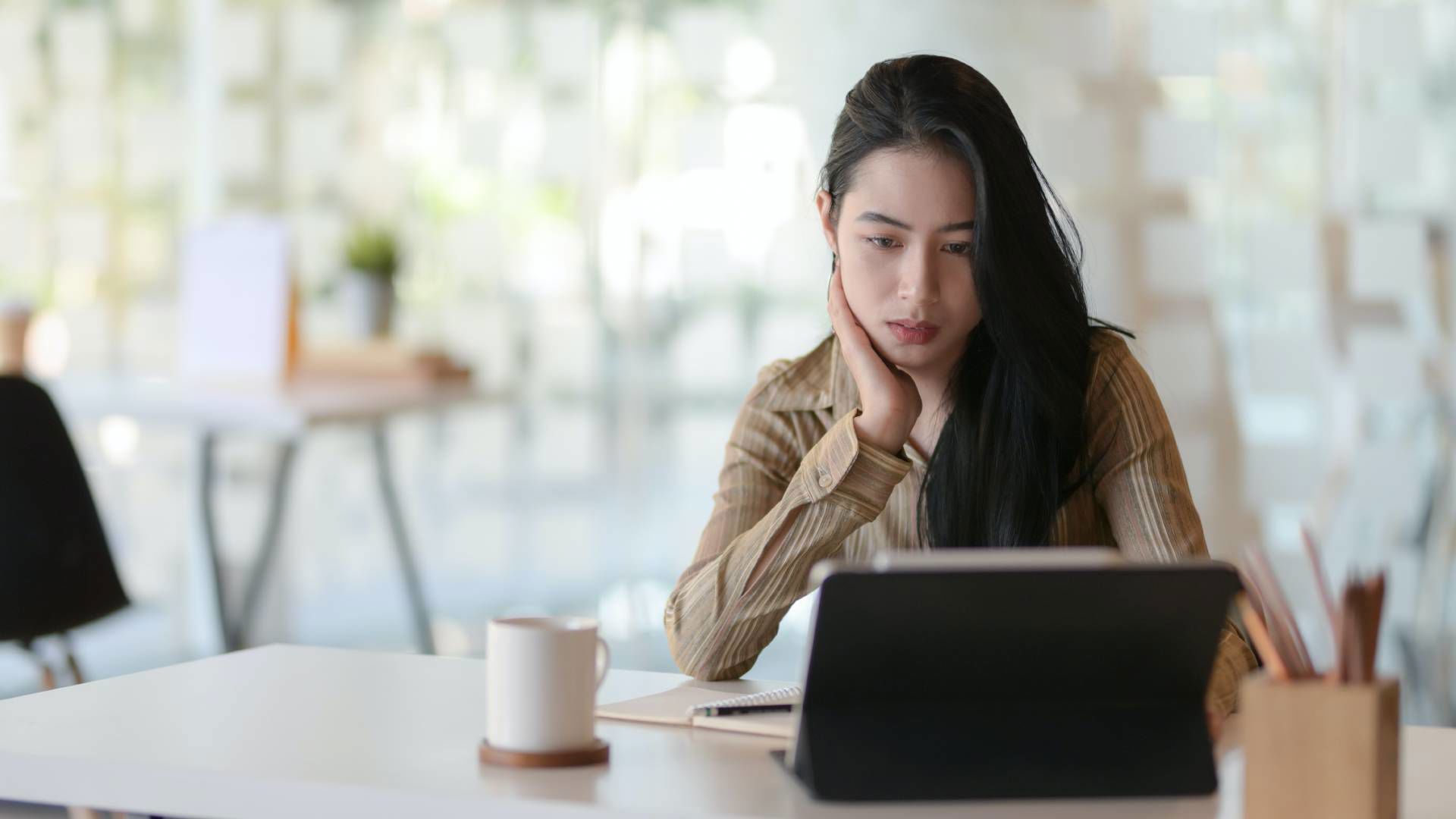 Asian female looks at computer