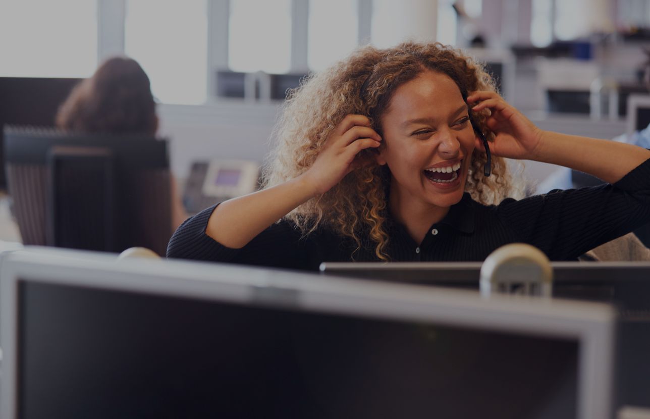 female sales consultant laughs on telesales call pareto 