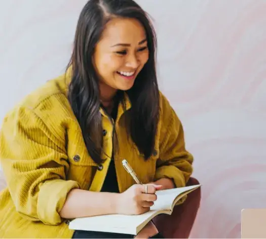 female writes in notebook