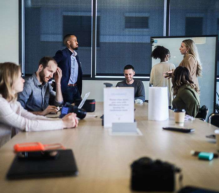 team meeting at a brown table in the office