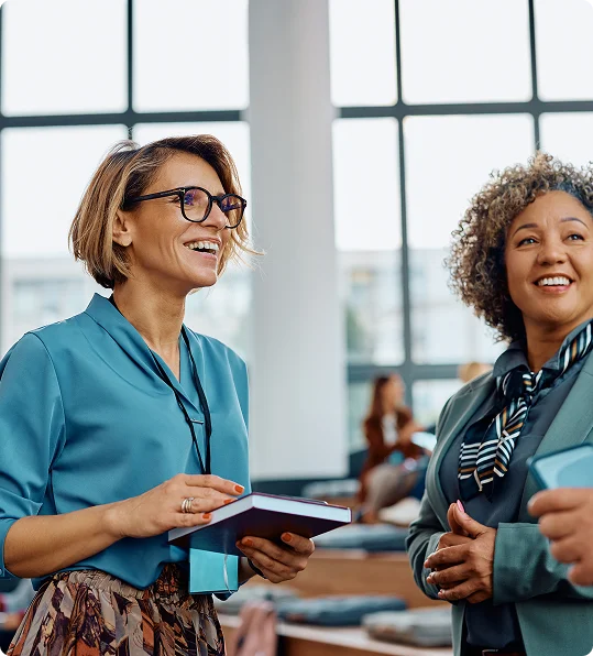 two women smiling in atrium