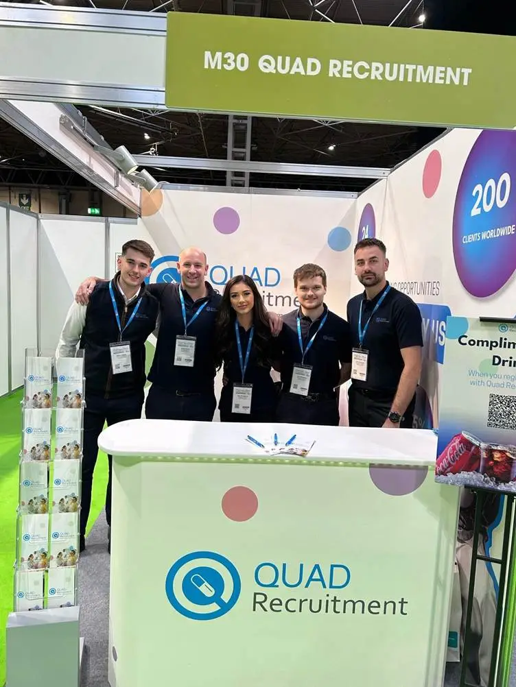 A group of people standing in front of a boothAI-generated content may be incorrect.
